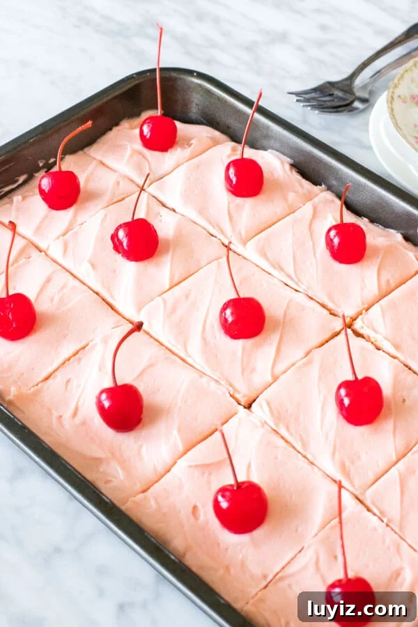 Moist Maraschino Cherry Cake Recipe with Cherry Glaze 2 A 9x13 inch pan of maraschino cherry cake sliced into pieces.