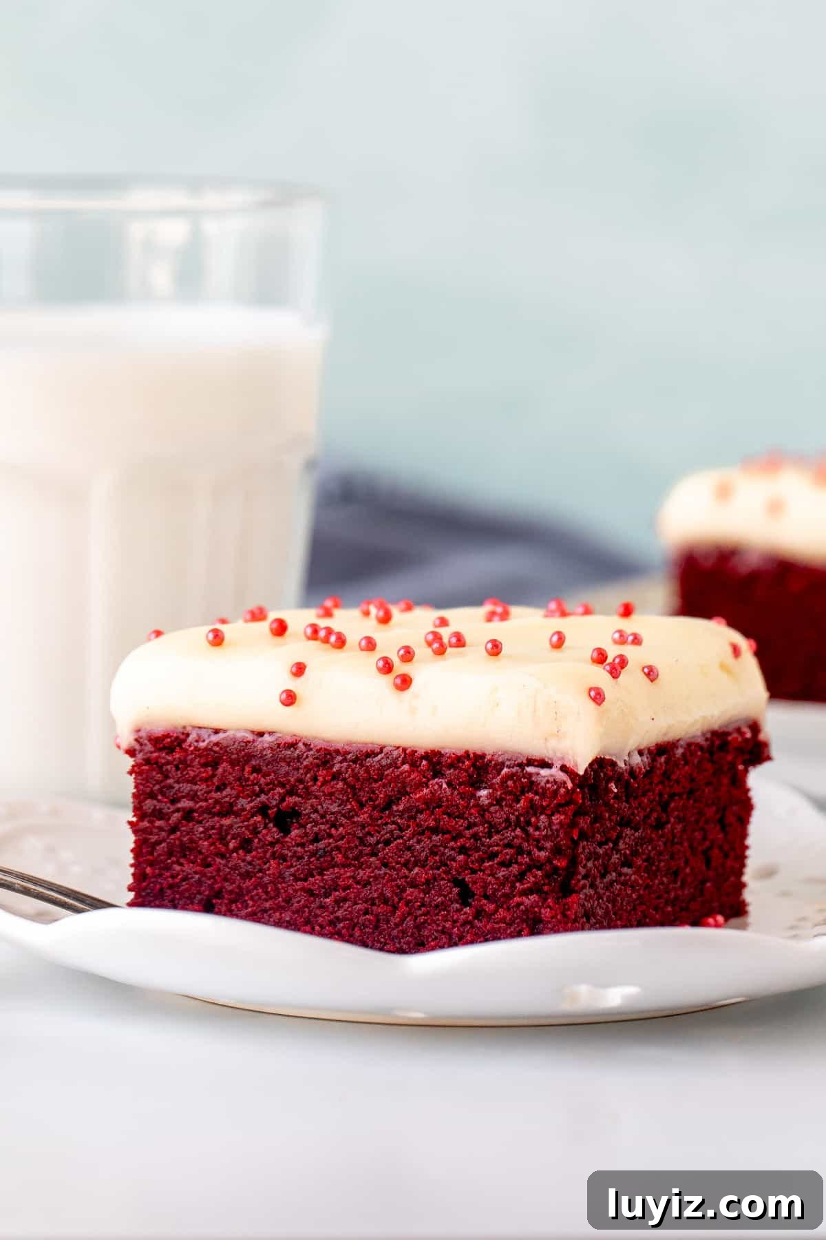 Red Velvet Brownies Recipe: Decadent Chocolate-Cream Cheese Bars 3 Red velvet brownie topped with cream cheese frosting with glass of milk