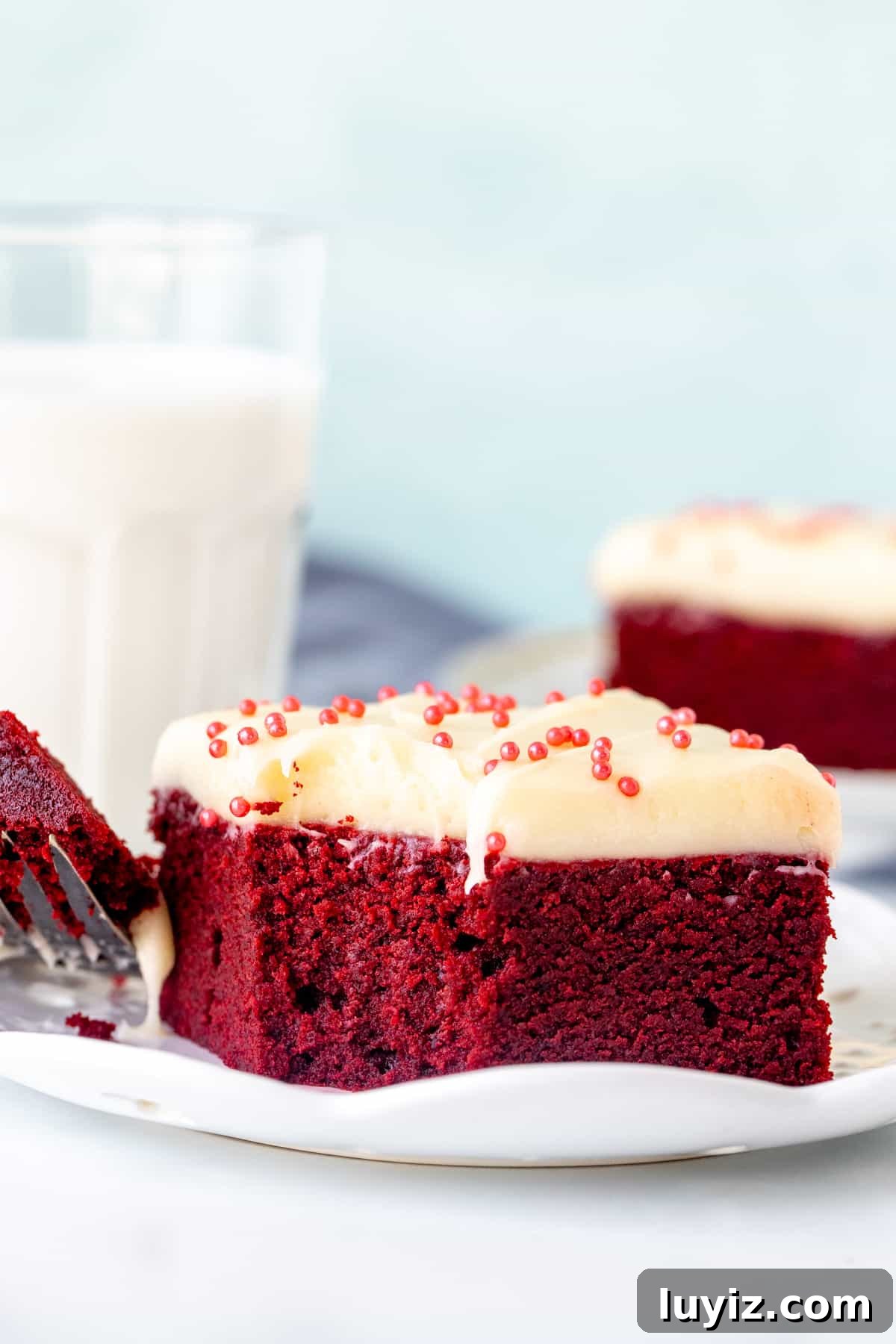 Red Velvet Brownies Recipe: Decadent Chocolate-Cream Cheese Bars 7 Red velvet brownie with cream cheese frosting, with a bite taken out