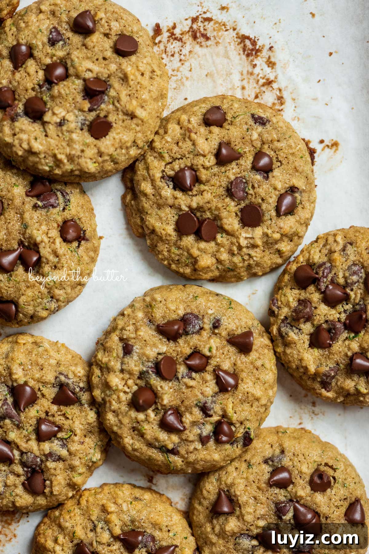 Moist Zucchini Chocolate Chip Oatmeal Cookies Recipe 4 Zucchini chocolate chip oatmeal cookies on a parchment paper lined baking sheet