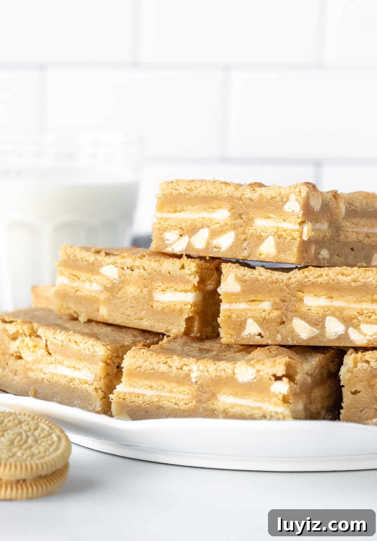 Chewy Golden Oreo Blondies Recipe for Dessert Lovers 3 Plate of golden Oreo blondies, stacked on top of each other.