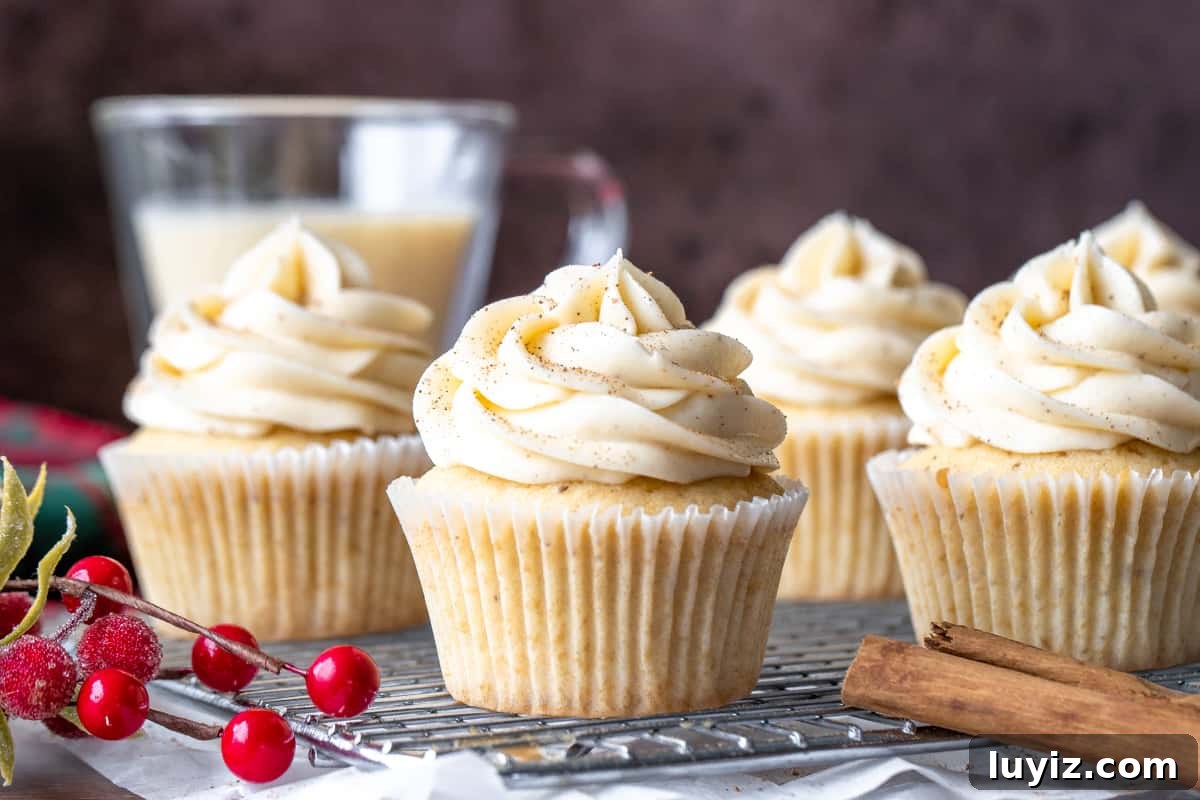 Decadent Eggnog Cupcakes with Spiced Buttercream Frosting 3 Eggnog cupcakes on wire rack