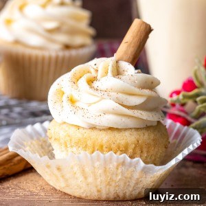 Decadent Eggnog Cupcakes with Spiced Buttercream Frosting 6 Eggnog cupcake with a glass of eggnog