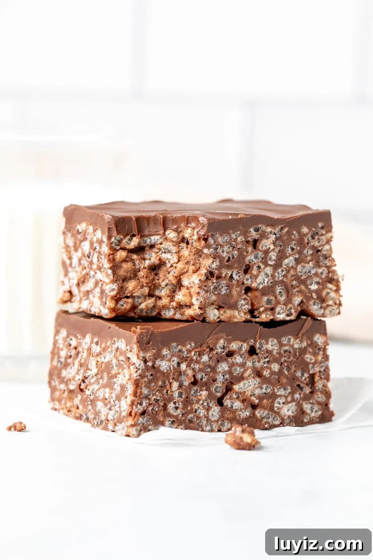 Decadent Chocolate Rice Krispie Treats Recipe 6 Two chocolate Rice Krispie treats with a bite taken out