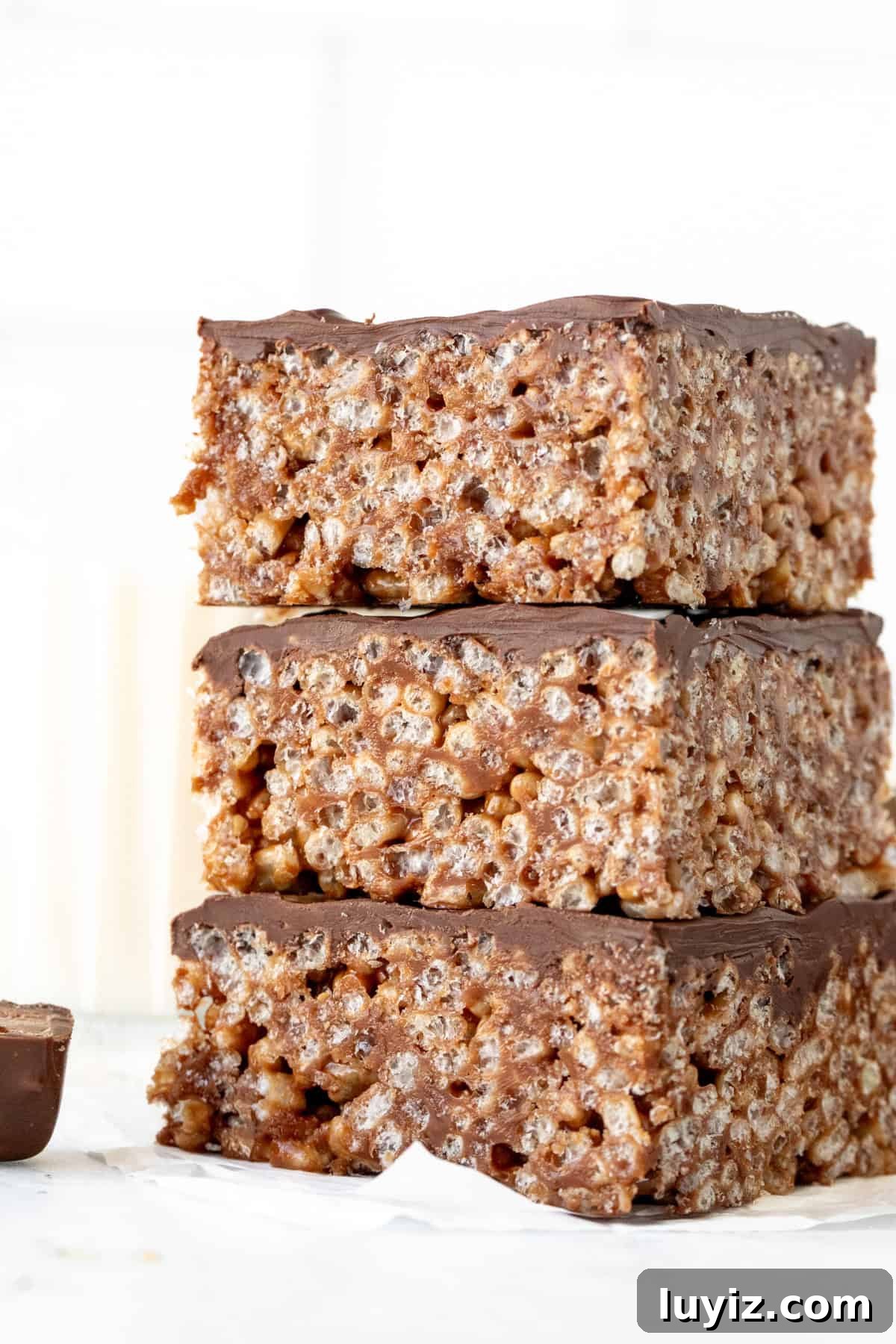 Chewy Mars Bar Squares Recipe with Chocolate Caramel Layer 3 Mars bar squares with chocolate topping, stacked on top of each other