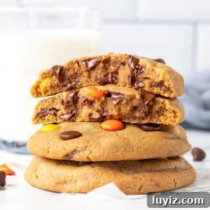Reese's Pieces Peanut Butter Cookies — Ultimate Recipe Guide 8 Stack of Reese's Pieces peanut butter cookies, with the top cookie broken in half.