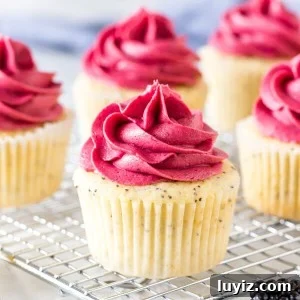 Lemon poppy seed cupcakes on a wire cooling rack.
