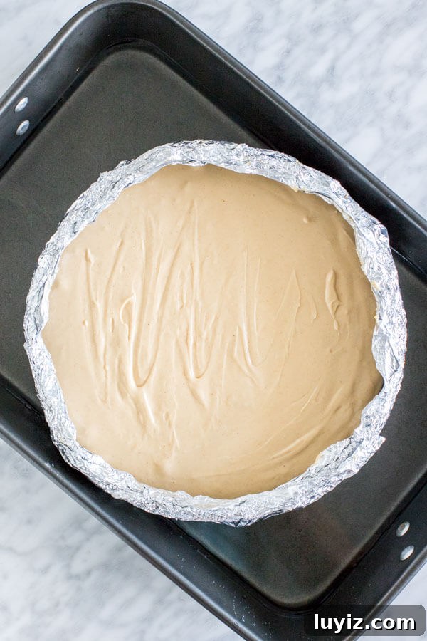 Monster Cookie Cheesecake Recipe: Decadent Layered Dessert Guide 4 Unbaked cheesecake, in water bath.