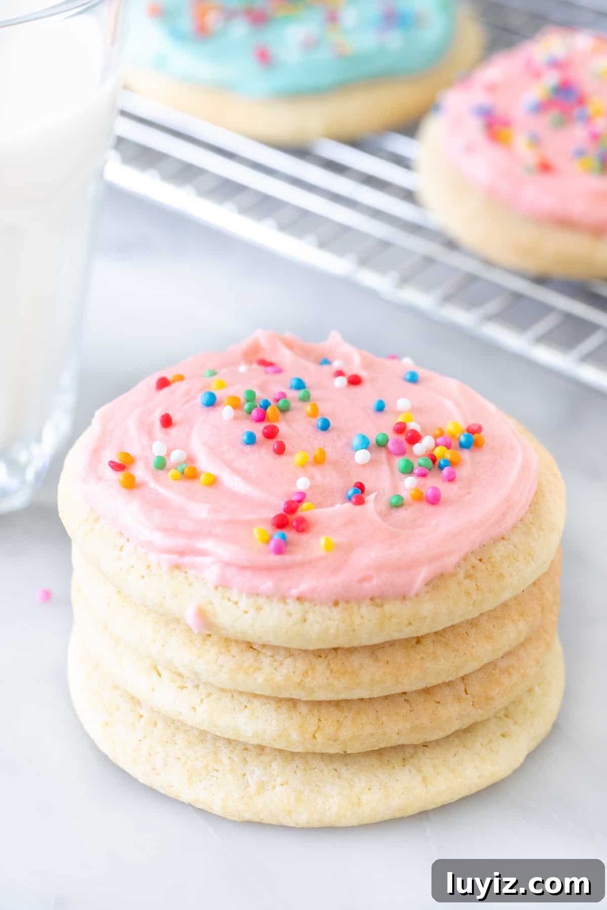 Soft-Batch Sour Cream Sugar Cookies — Ultra-Soft, Tender Cookies 4 Stack of sugar cookies with a glass of milk