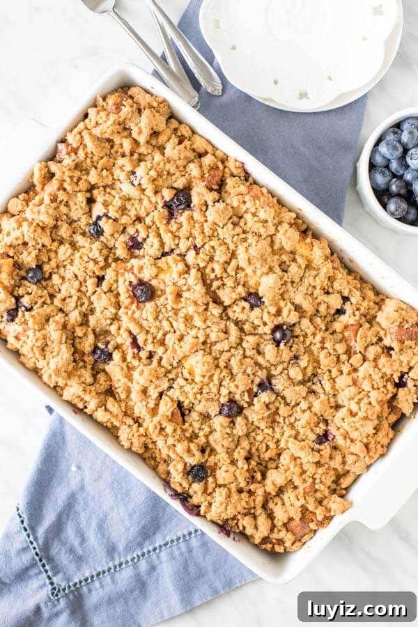 Blueberry French Toast Casserole Recipe for Brunch and Holidays 3 9x13 inch pan of blueberry french toast casserole with cinnamon streusel topping.