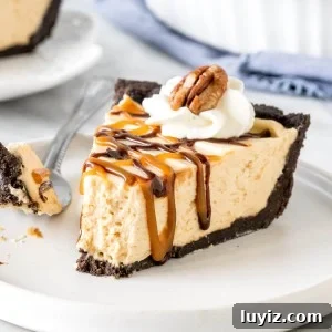Decadent Turtle Pie Recipe with Pecan-Caramel Crunch 5 Slice of turtle pie with Oreo crust on a plate with a bite taken out of it.