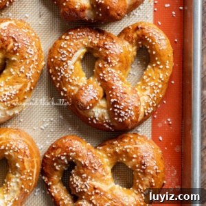 How to Make Soft Homemade Pretzels Step-by-Step 14 Homemade soft pretzels on a silicone baking mat and baking sheet.