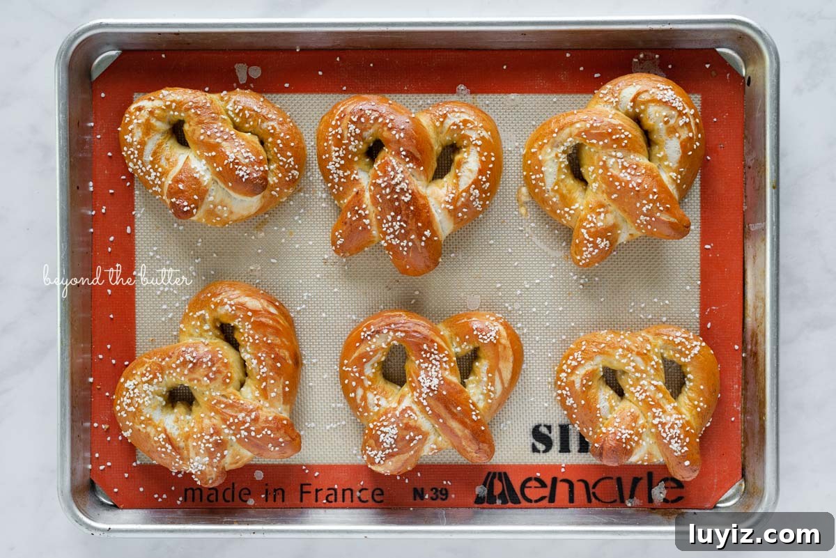 How to Make Soft Homemade Pretzels Step-by-Step 8 Baked homemade soft pretzels on silicone lined baking sheet