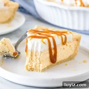 Decadent Caramel Cream Pie Recipe: Silky, No-Bake Dessert 5 Slice of no-bake caramel cream pie with a bite taken out of it.