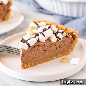 Decadent Rocky Road Pie Recipe: Chocolate, Marshmallows & Nuts 4 Slice of rocky road cheesecake pie topped with marshmallows.