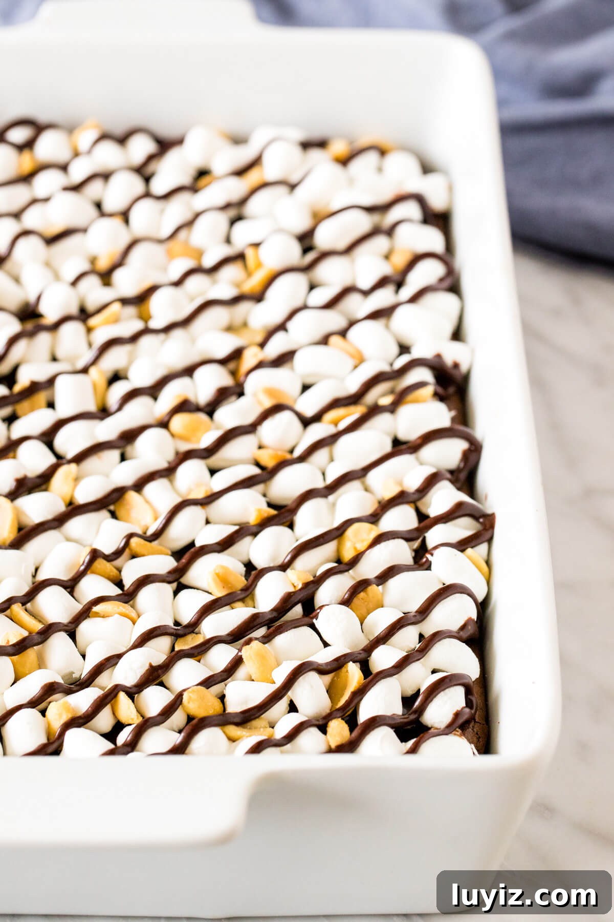 Decadent Rocky Road Brownies Recipe with Chocolate & Marshmallows 3 9x13 inch pan of brownies topped with marshmallows, peanuts and a drizzle of chocolate