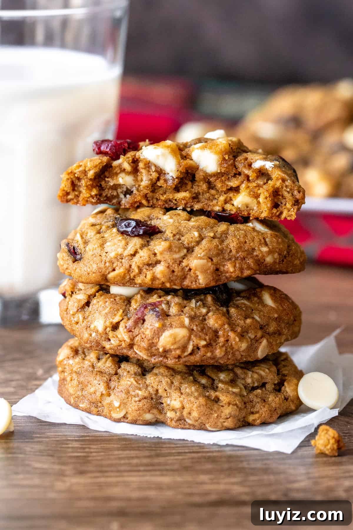 White Chocolate Cranberry Oatmeal Cookie Recipe for Chewy Bliss 4 Stack of white chocolate cranberry oatmeal cookies with top cookie broken in half