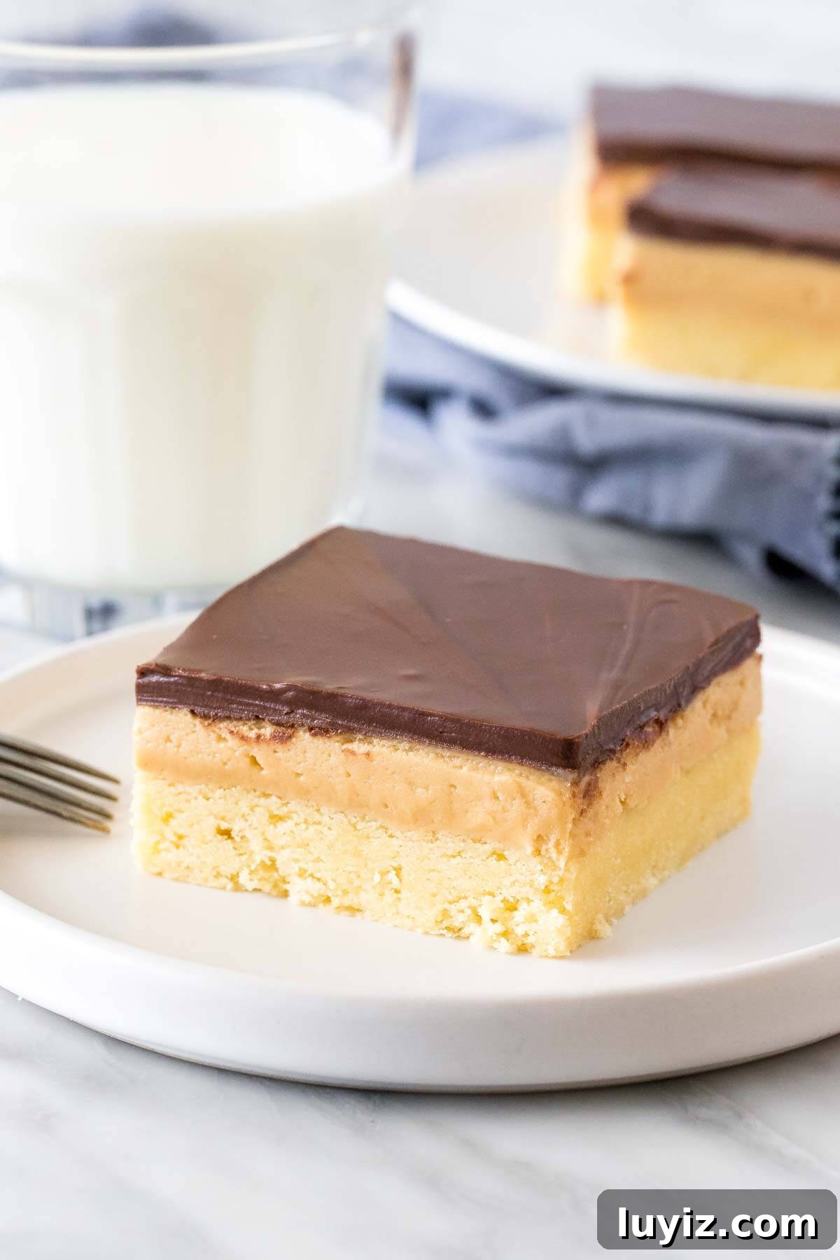 Peanut Butter Shortbread Bars Recipe — Buttery, Crunchy Treat 6 Peanut butter millionaire's shortbread bar on a plate with a glass of milk.