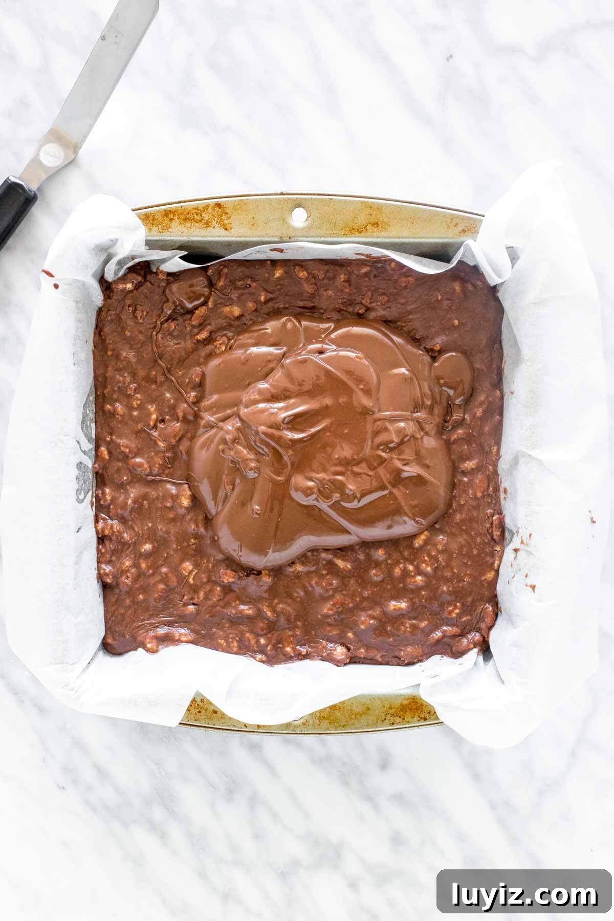No-Bake Malteser Slice Recipe — Crunchy Chocolate Slice 4 Chocolate poured over a pan of Malteser slice.