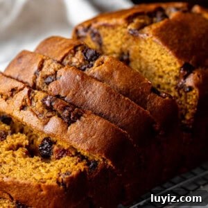 Pumpkin Chocolate Chip Loaf Recipe: Moist Spiced Quick Bread 8 Pumpkin chocolate chip bread on a cooling rack with 5 pieces sliced