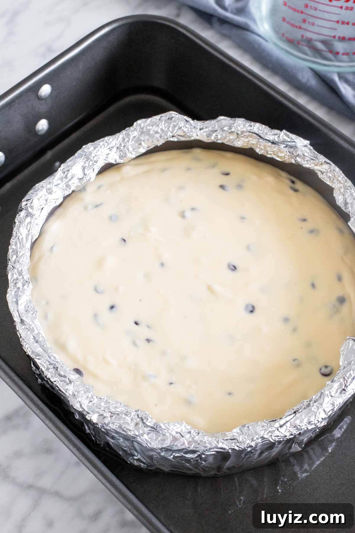 Decadent Chocolate Chip Cheesecake Recipe for Dessert Lovers 4 Unbaked cheesecake in a water bath