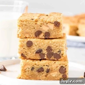 Stack of 3 peanut butter cookie bars with chocolate chips.