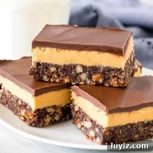 Plate of peanut butter nanaimo bars with a glass of milk