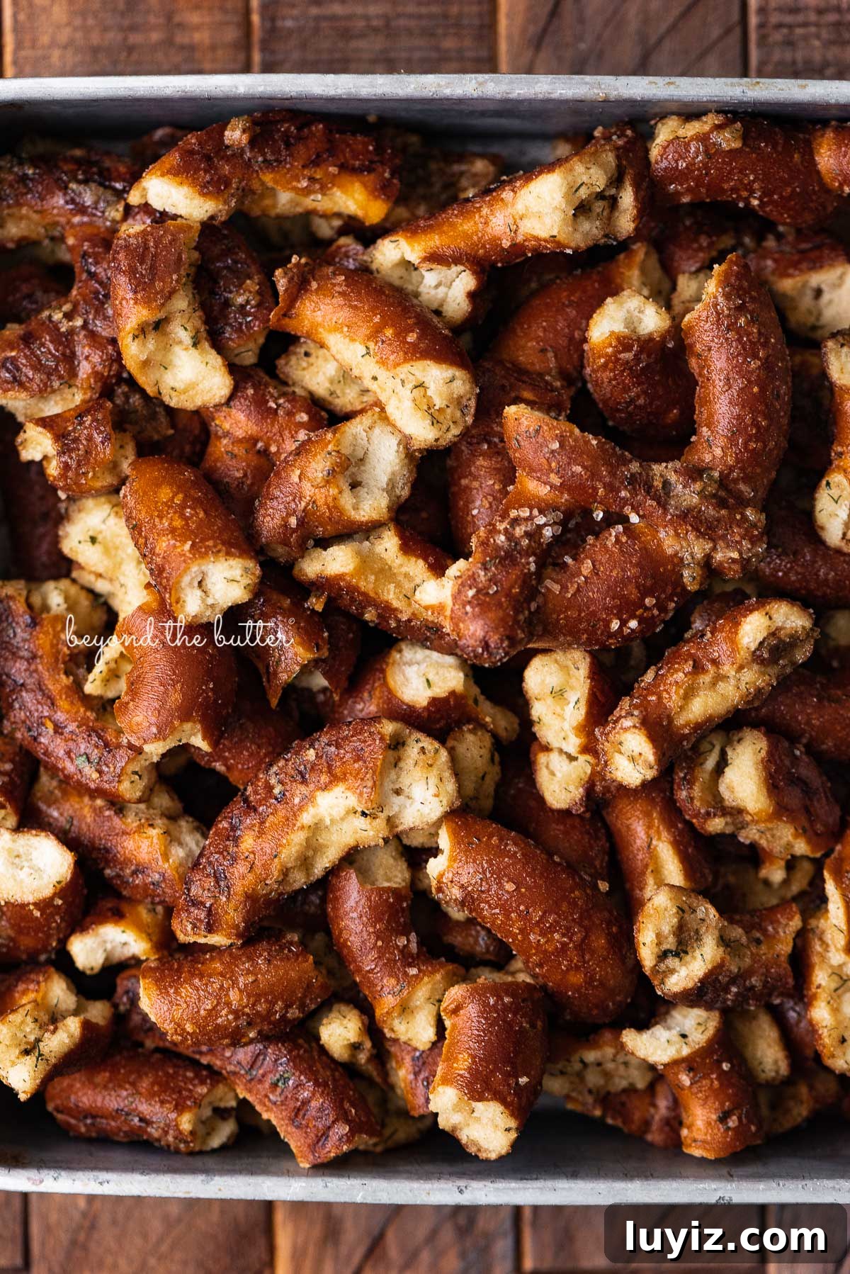 Savory Seasoned Pretzels: Flavorful Homemade Snack Recipe 5 8 inch vintage square baking pan filled with seasoned pretzels | © Beyond the Butter®