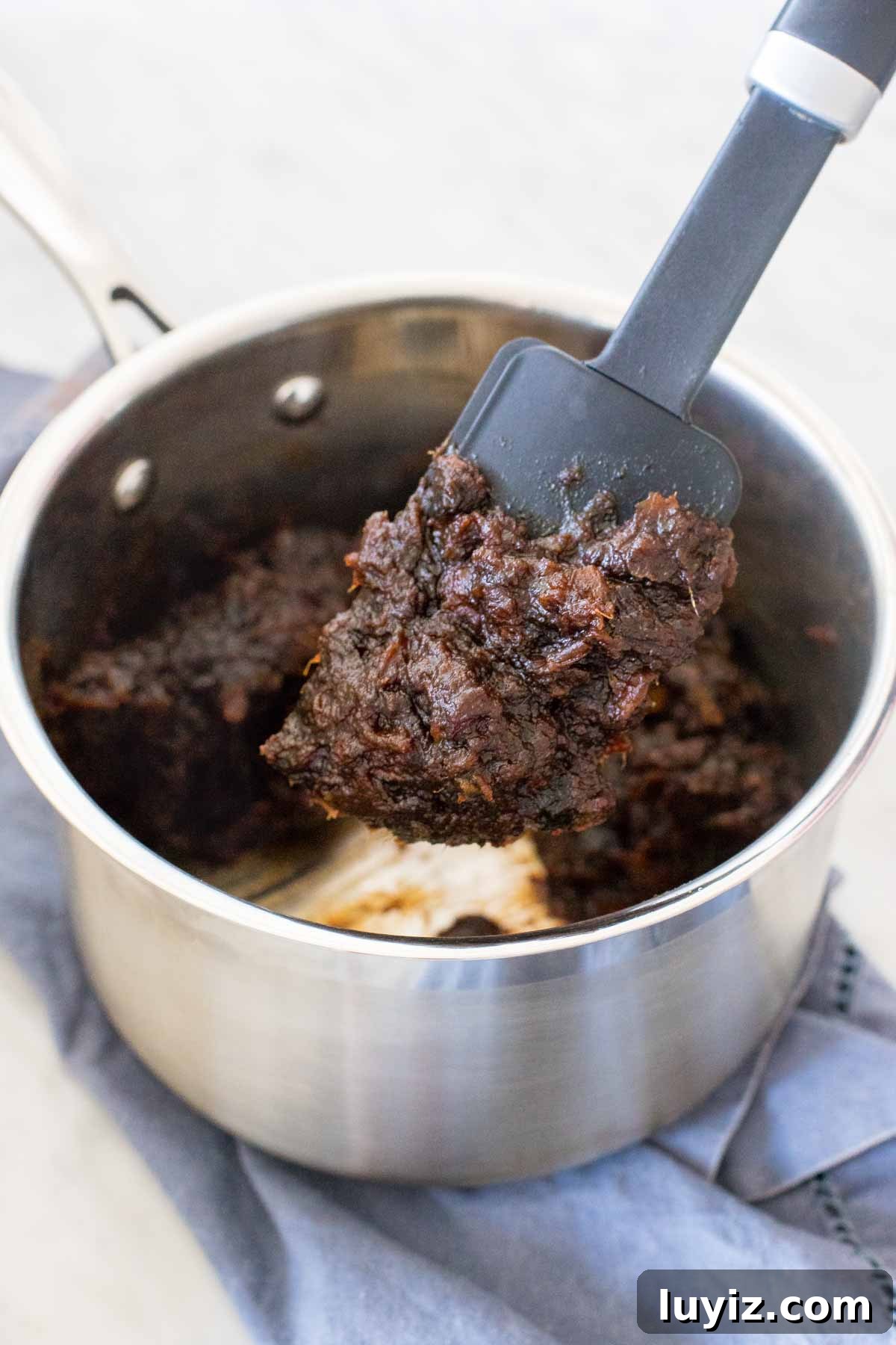 Date Squares Recipe: Chewy No-Bake Date Bars with Oats 3 Boiled date mixture in a pan.