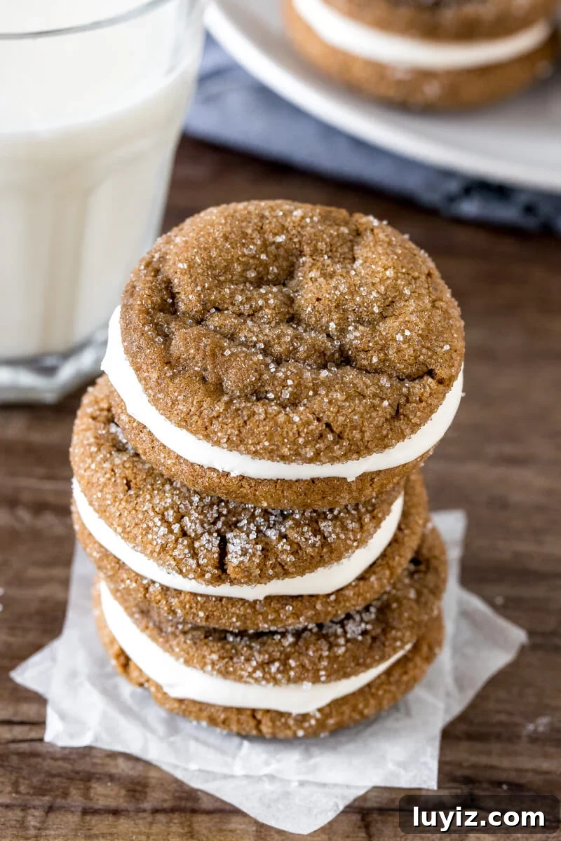 Molasses Cream Pie Cookies Recipe — Soft Spiced Cookie Sandwiches 2 Stack of 3 ginger cream pie cookies with a glass of milk.