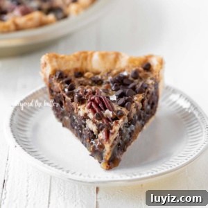 Decadent Chocolate Pecan Pie Recipe for Chocoholics 7 Slices of chocolate pecan pie on dessert plates on white wood table.