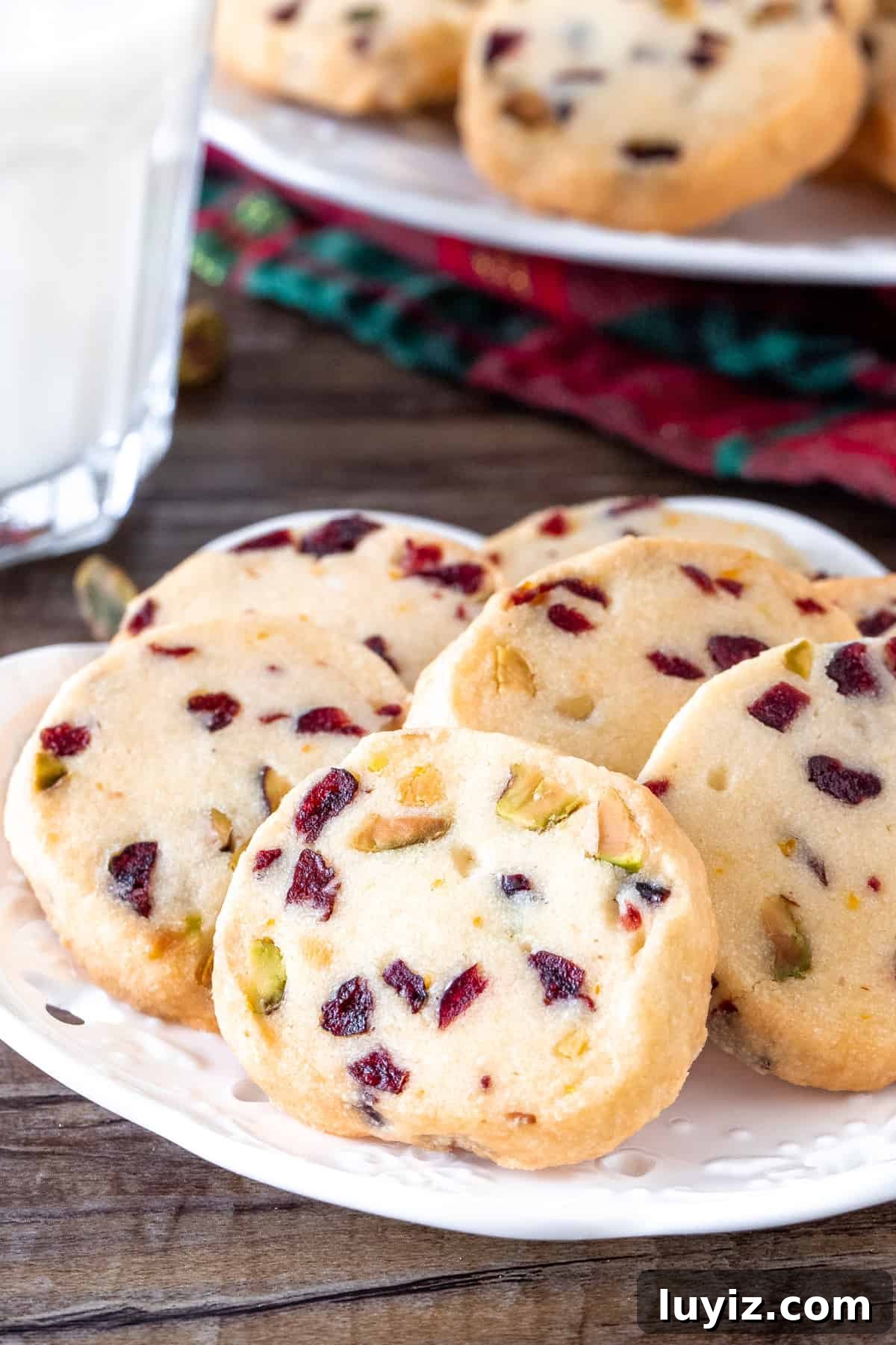 Cranberry Pistachio Shortbread Cookies Recipe 5 Cranberry orange shortbread on a plate with a glass of milk.