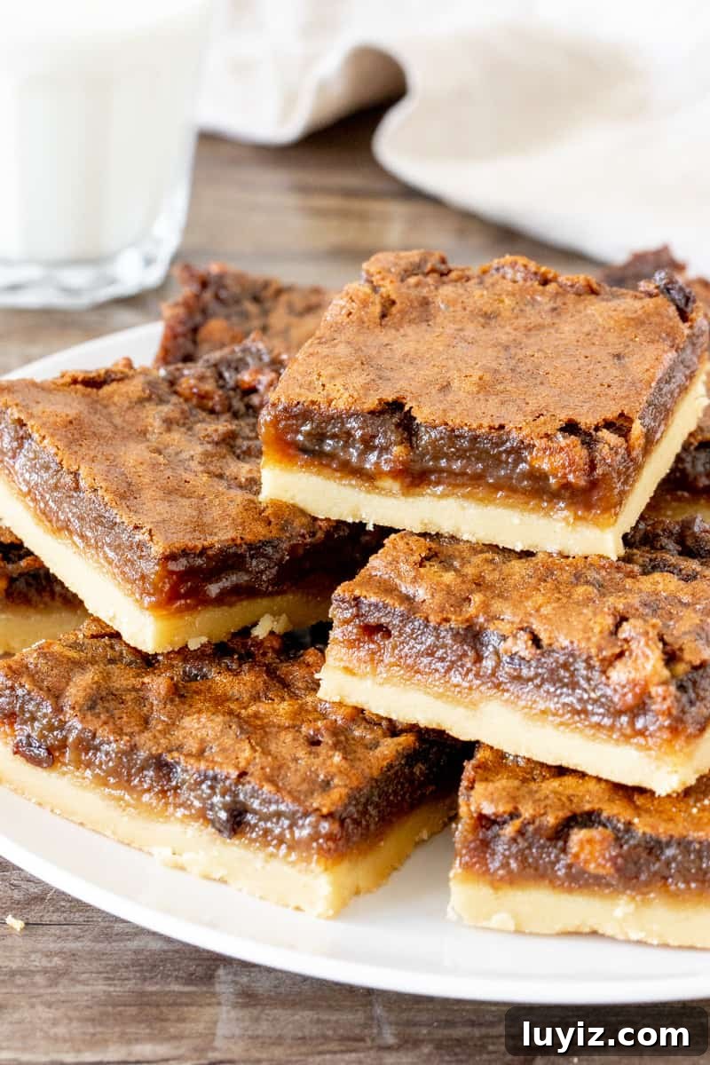 Classic Butter Tart Squares Recipe — Gooey Canadian Dessert 3 Plate of sliced butter tart bars.