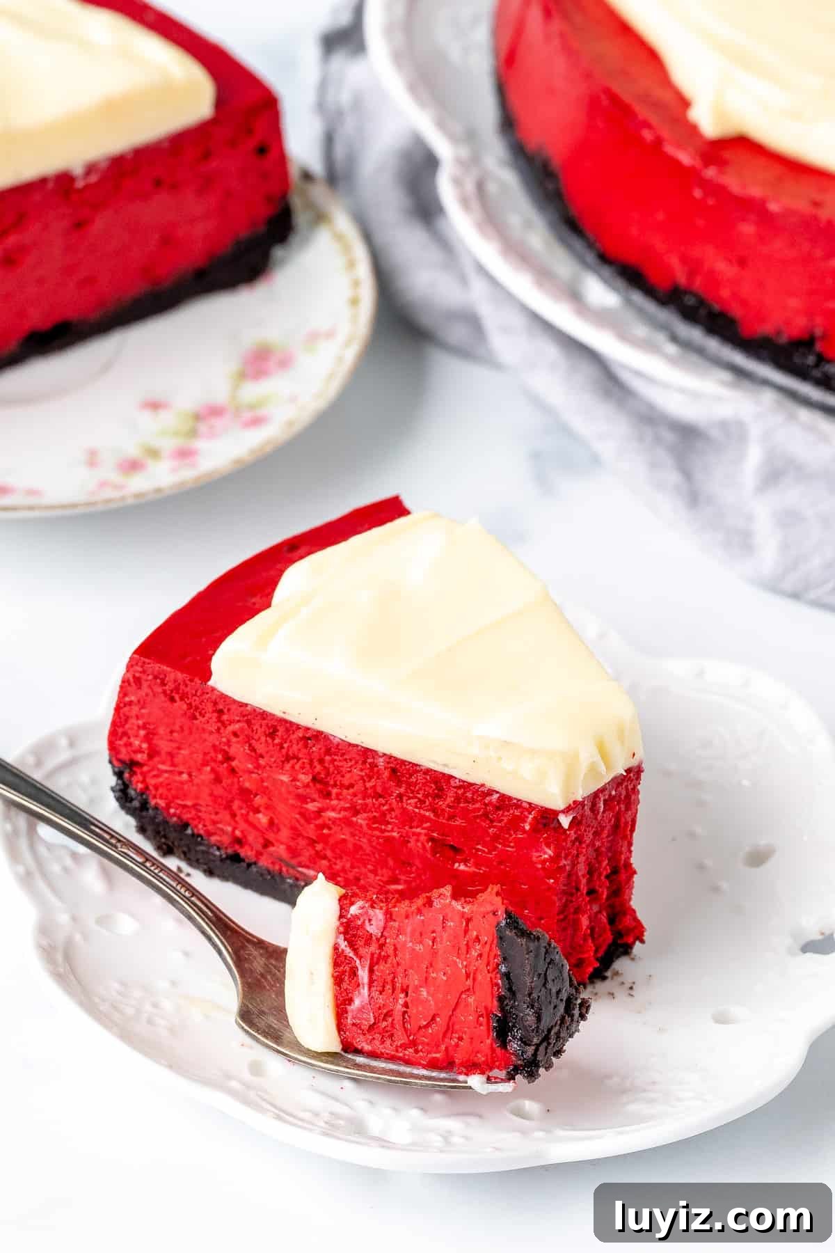 Decadent Red Velvet Cheesecake Recipe for Every Occasion 5 Slice of red velvet cheesecake with a bite taken out of it