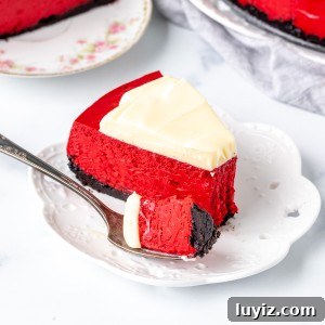 Decadent Red Velvet Cheesecake Recipe for Every Occasion 6 Piece of red cheesecake with cream cheese frosting and an Oreo crust