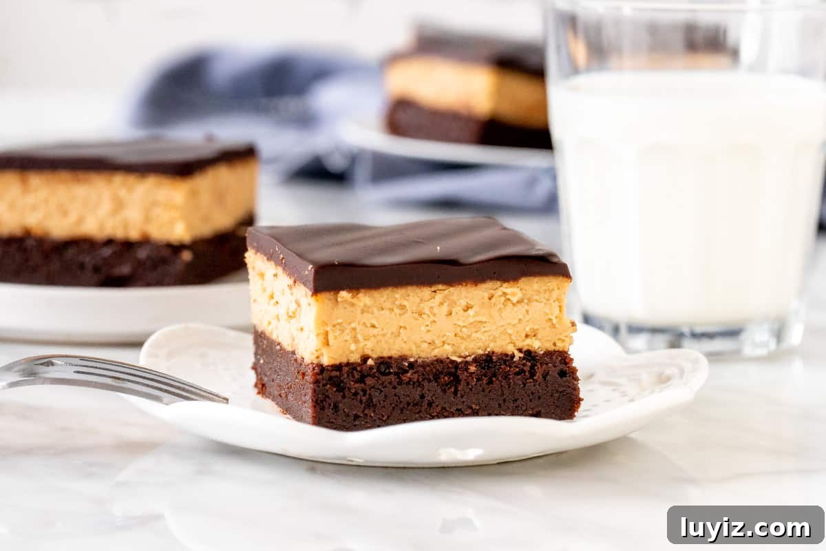 Peanut Butter Swirl Cheesecake Brownies Recipe 3 Triple layer peanut butter brownie on a plate.