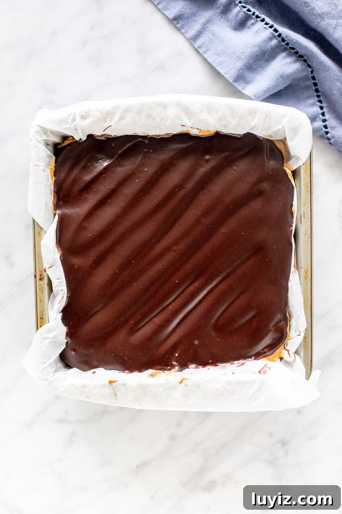 Peanut Butter Swirl Cheesecake Brownies Recipe 4 8x8 inch pan of brownies with chocolate topping.