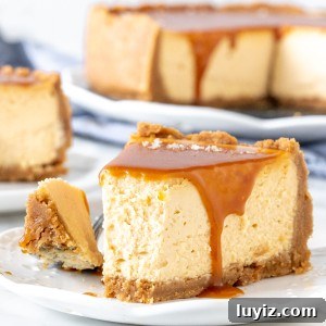 Slice of caramel cheesecake with a bite taken out of it.