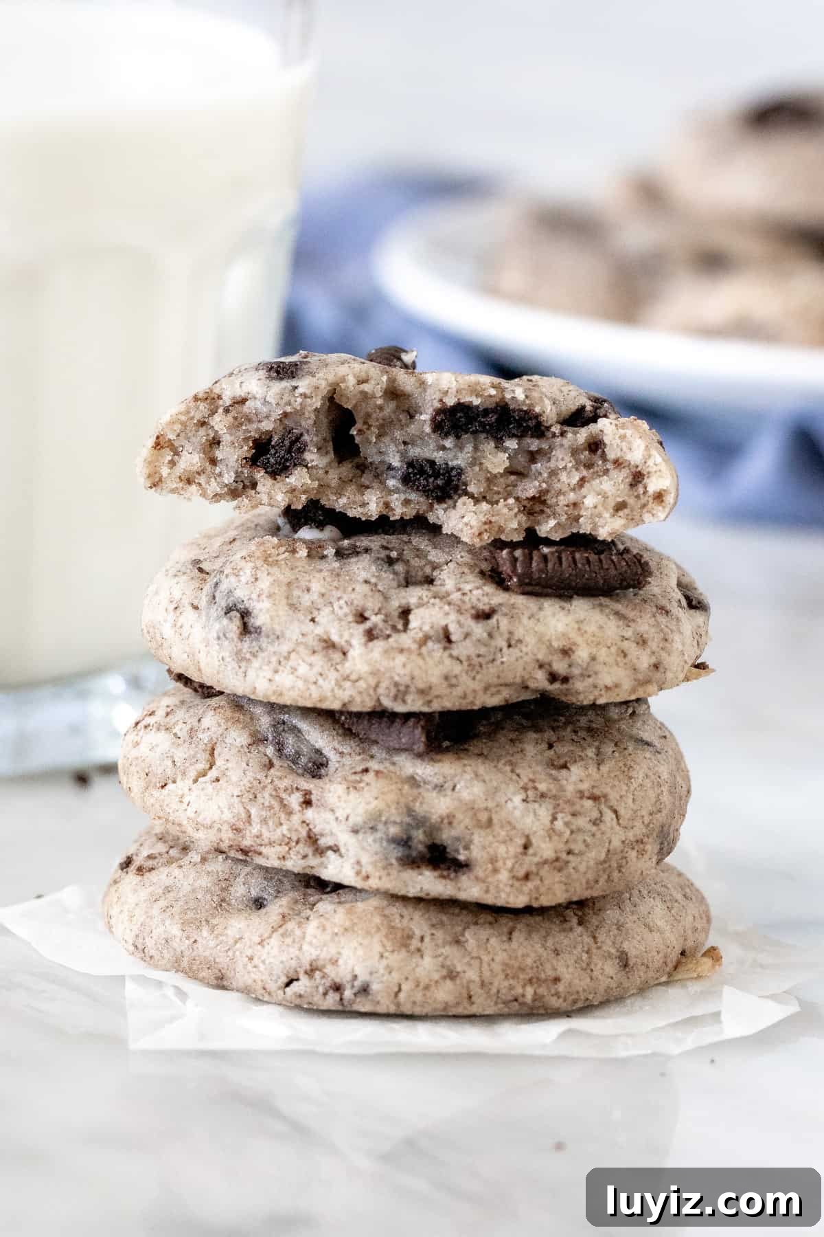 Oreo Cheesecake Stuffed Cookies: Decadent No-Bake Recipe 2 Stack of Oreo cheesecake cookies with the top cookie broken in half.
