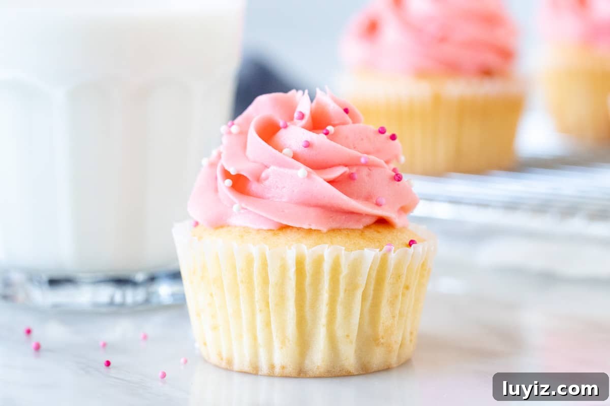 Perfect Small-Batch Vanilla Cupcakes Recipe for 12 Cupcakes 4 Vanilla cupcake with vanilla frosting and a glass of milk