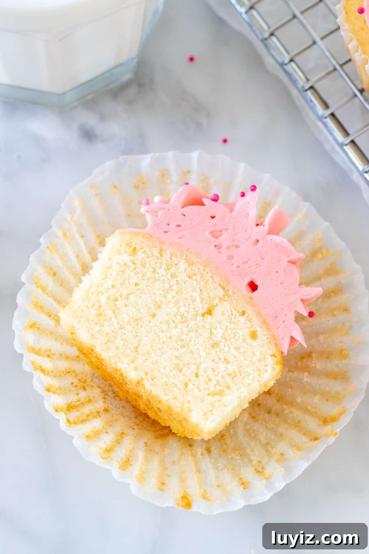 Perfect Small-Batch Vanilla Cupcakes Recipe for 12 Cupcakes 5 Vanilla cupcake cut in half in a cupcake paper