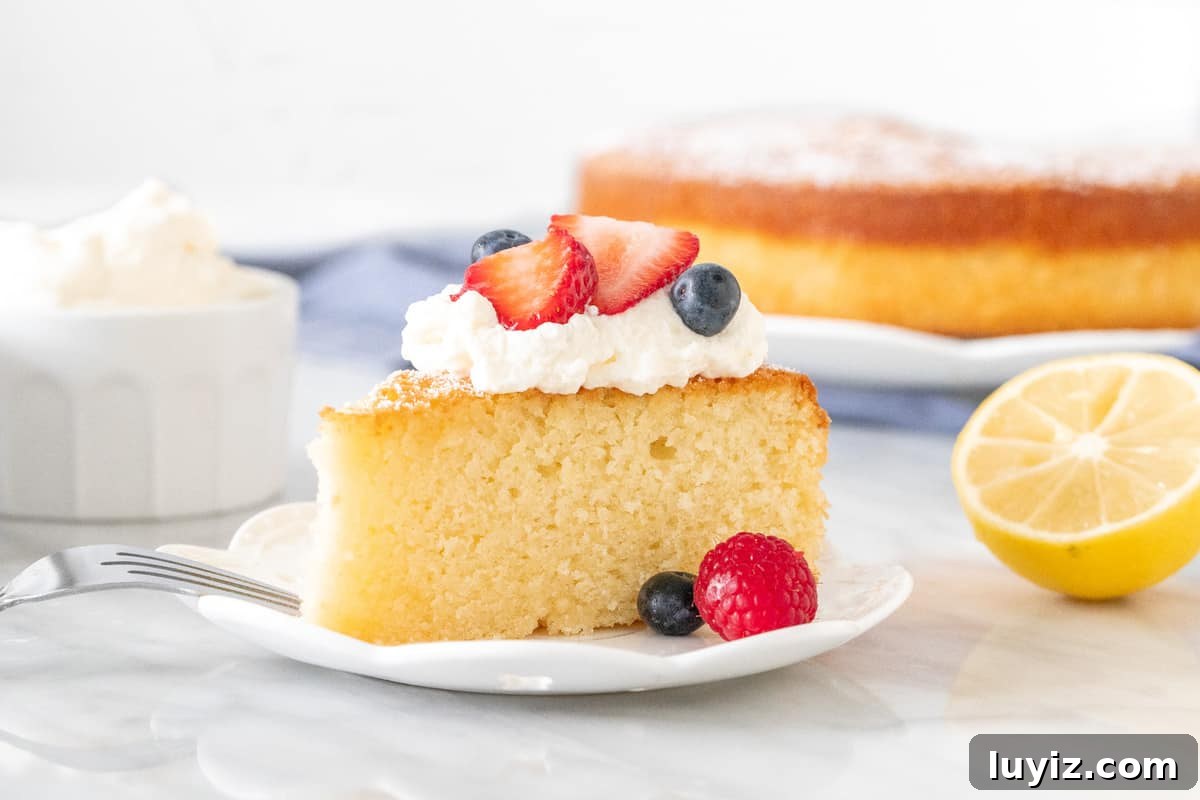Lemon Olive Oil Cake Recipe: Moist Citrus Dessert for Any Occasion 4 Slice of plain cake with berries and cream on top.