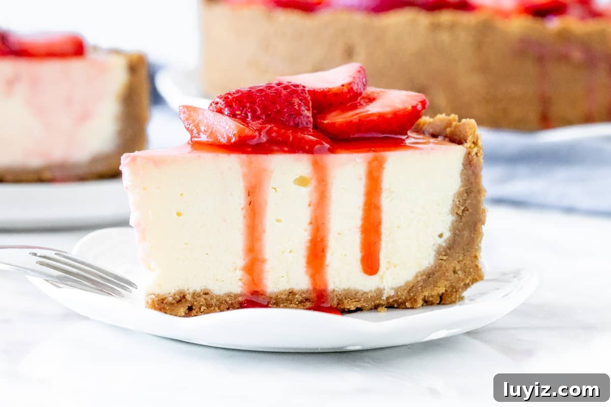 Decadent Strawberry Cheesecake Recipe with Fresh Strawberry Glaze 3 Slice of cheesecake with strawberries on top.