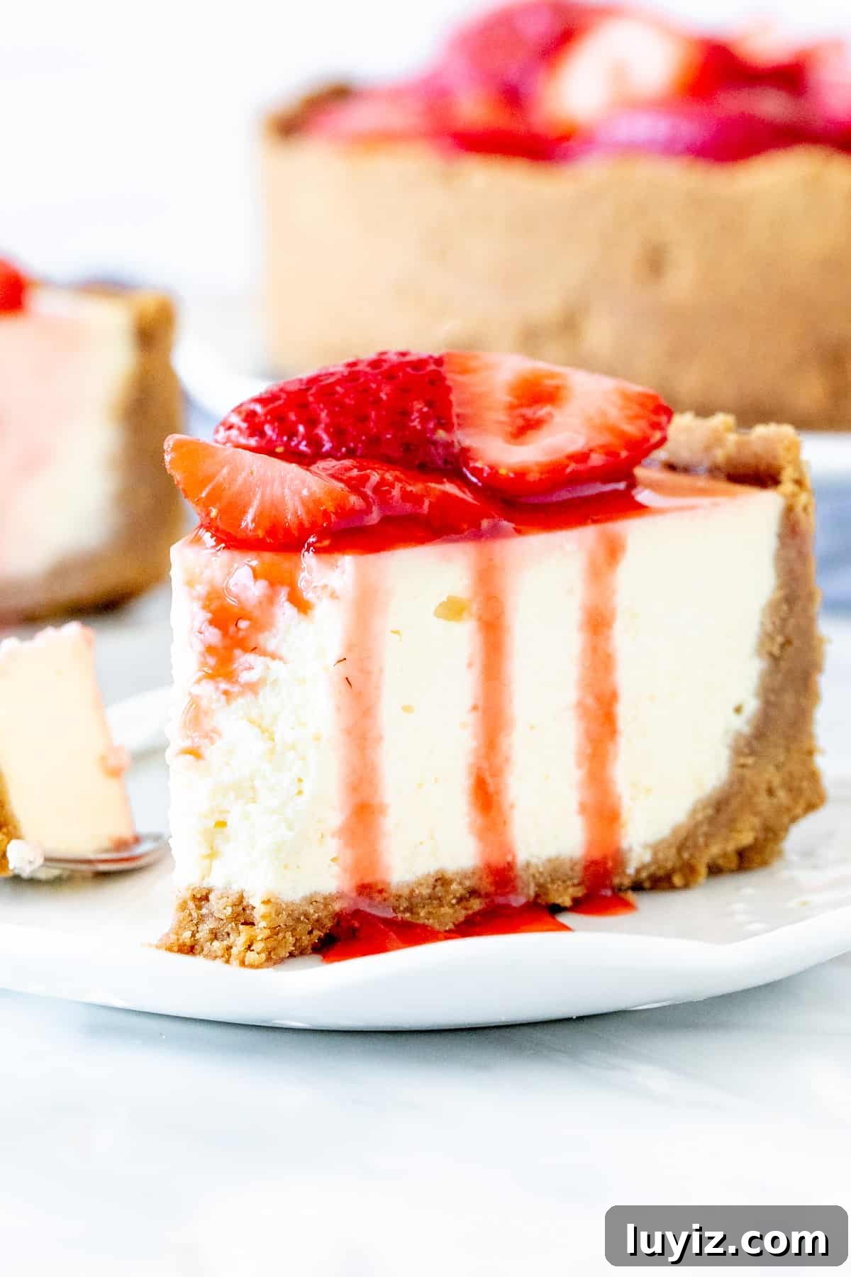 Decadent Strawberry Cheesecake Recipe with Fresh Strawberry Glaze 5 Slice of strawberry cheesecake on a plate