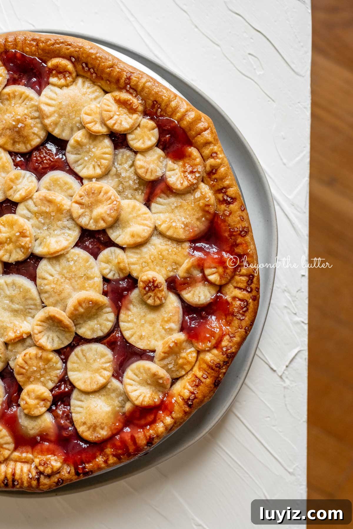 Classic Homemade Cherry Pie Recipe for Perfect Crust and Filling 5 Image of cherry pie placed close to the edge of the table | All Images © Beyond the Butter™