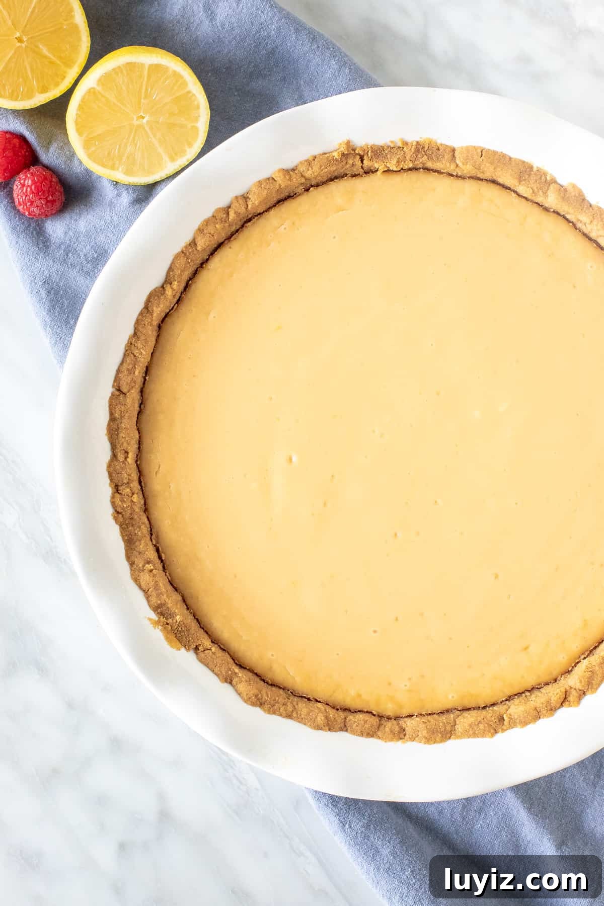 Creamy Lemon Pie Recipe: Tangy No-Bake Dessert with Graham Crust 3 Baked pie in a pie plate.
