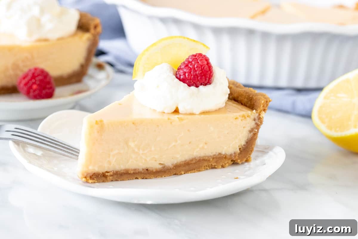 Creamy Lemon Pie Recipe: Tangy No-Bake Dessert with Graham Crust 5 Slice of lemon creamy pie with whipped cream on top