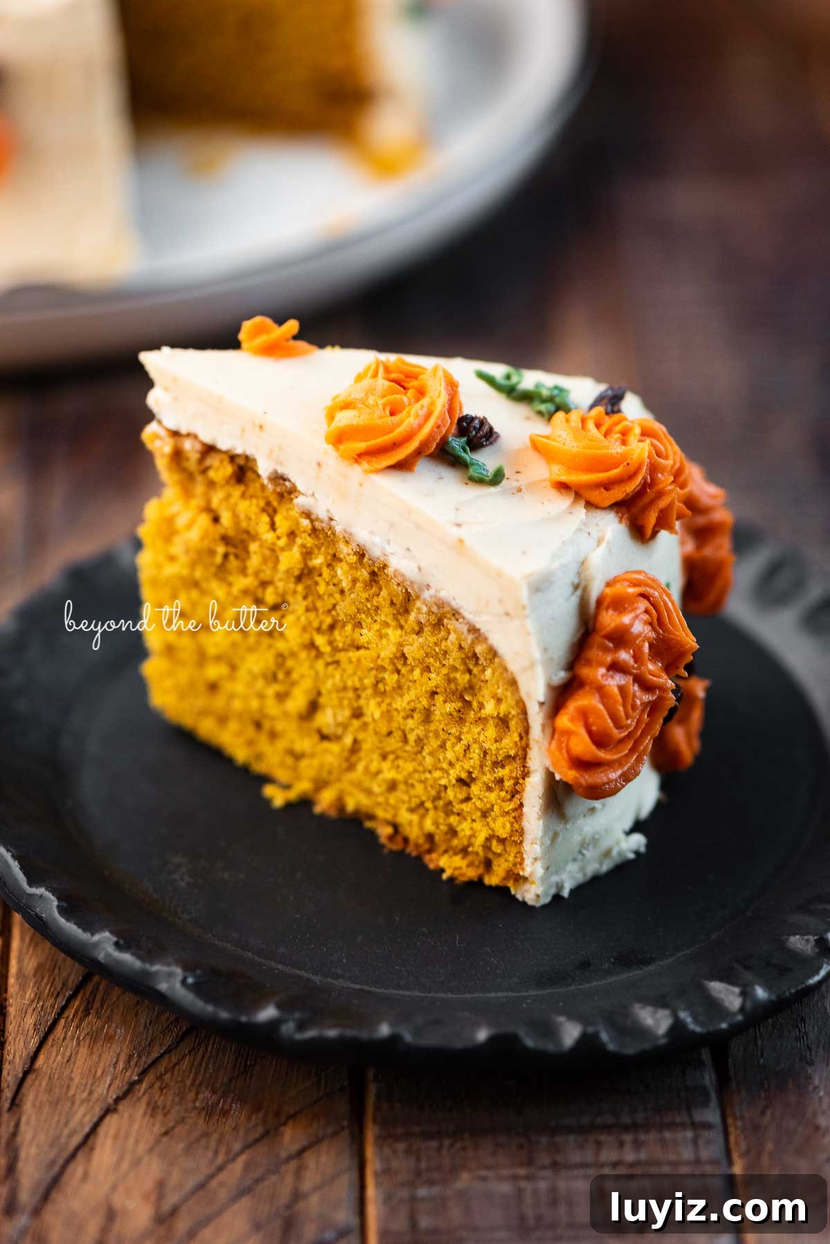 Single-Layer Pumpkin Spice Cake Recipe for Moist Fall Desserts 3 Slice of pumpkin spice cake on a small black dessert plate | © Beyond the Butter®