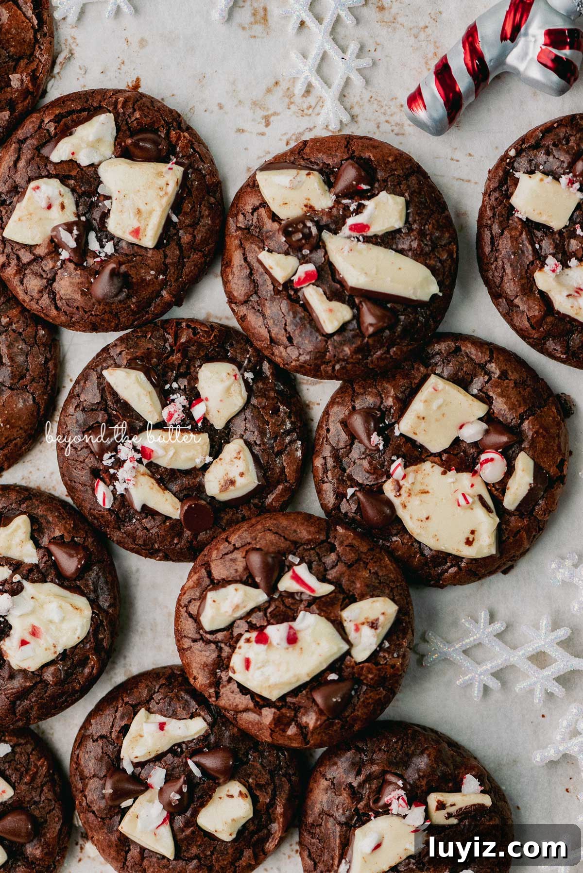 Peppermint Bark Brownie Crinkle Cookies Recipe for the Holidays 7 Just baked peppermint bark brownie crinkle cookies on a parchment paper lined baking sheet | © Beyond the Buter®