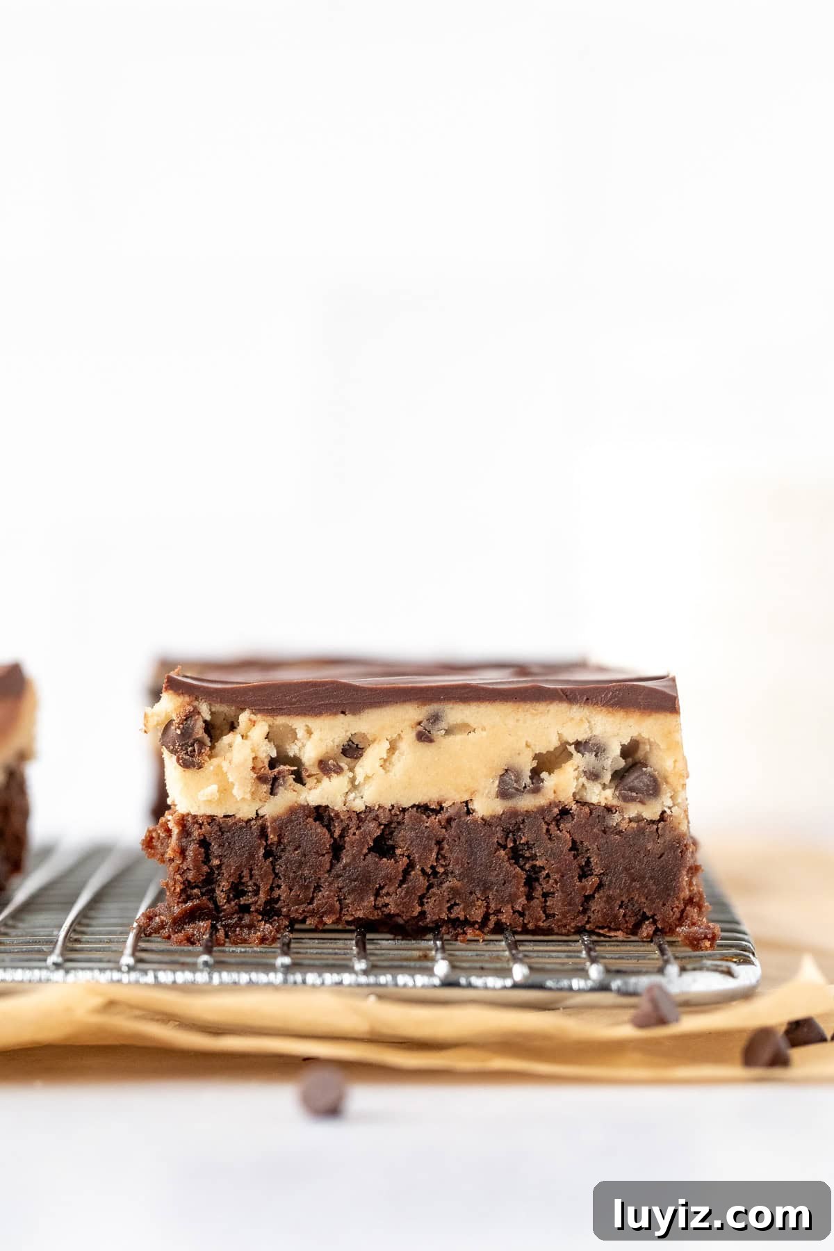 Cookie Dough Brownies Recipe: Chewy Brownies with Edible Cookie Dough Topping 4 Brownie with edible cookie dough layer and chocolate topping on a cooling rack